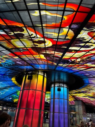 A colorful ceiling and pillars with a stained glass design