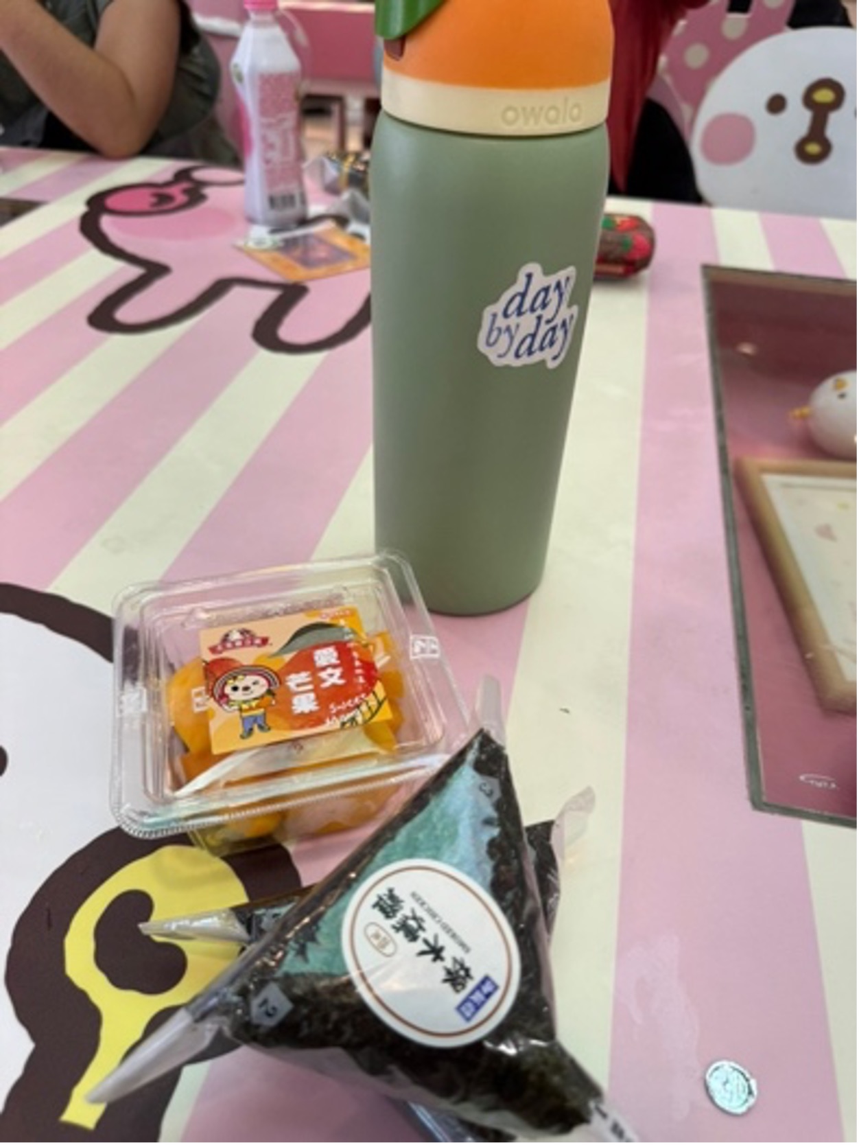 粽子 rice ball, mango slices, and my Owala bottle on a table.