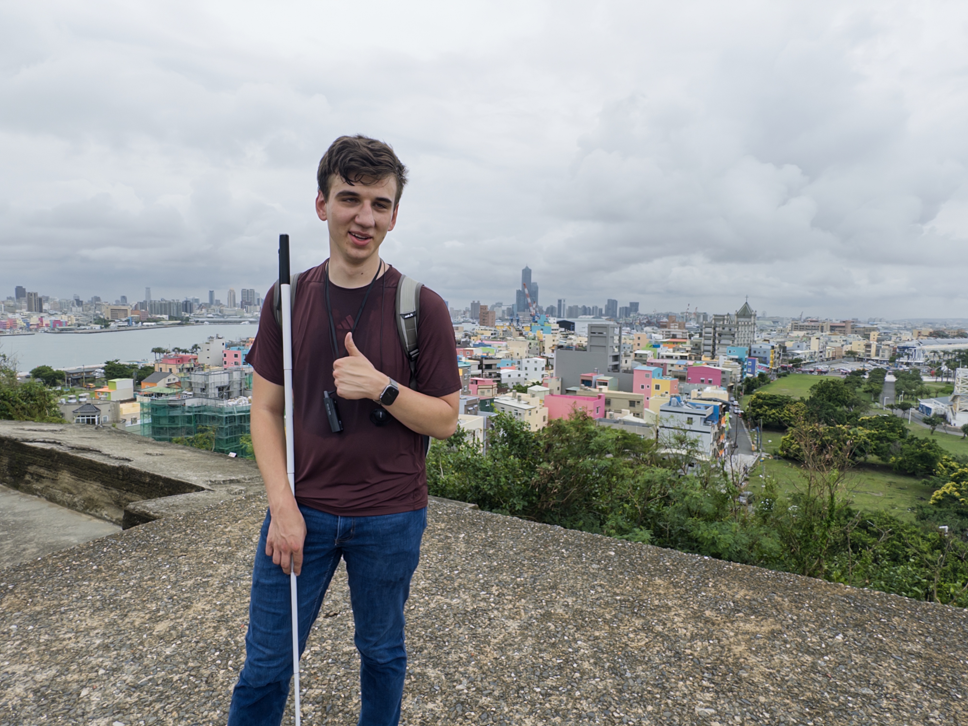 Me posing for a photo on top of a fort with the city of the island in the background.